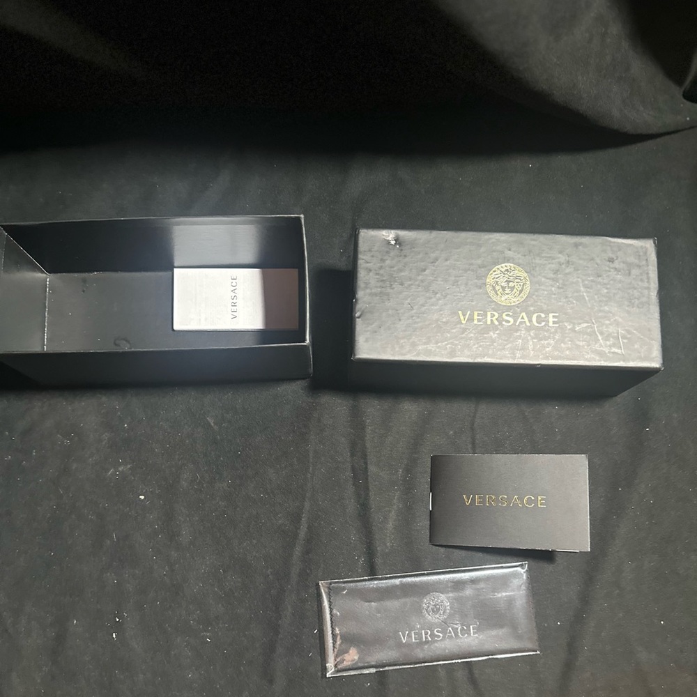 Versace sunglasses box with accessories and paperwork
